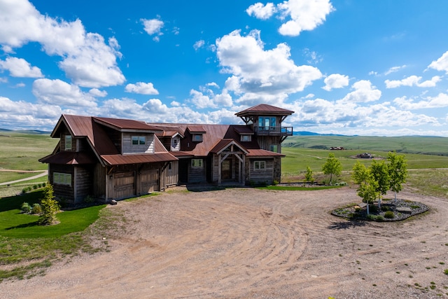 99 Little Belt Way, Belt, MT 59412 - view of front facade featuring dirt driveway, metal roof, a rural view, and an attached garage