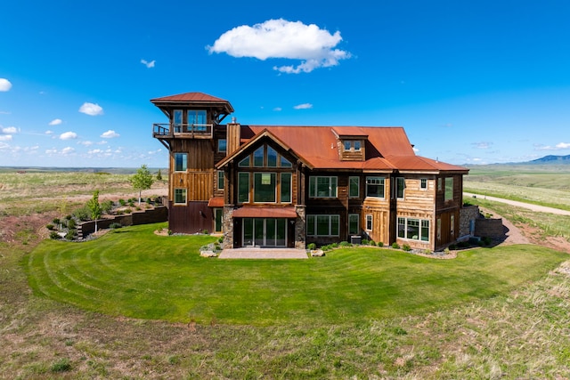 99 Little Belt Way, Belt, MT 59412 - back of property featuring a lawn, metal roof, and stone siding