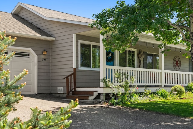 370 Prospector Trl, Bozeman, MT 59718 - property entrance featuring a porch, a garage, and roof with shingles