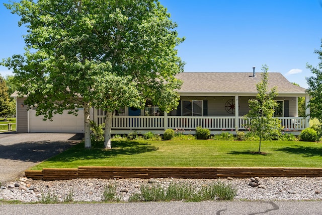 370 Prospector Trl, Bozeman, MT 59718 - view of front facade with asphalt driveway, a front yard, an attached garage, a porch, and roof with shingles