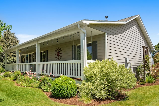 370 Prospector Trl, Bozeman, MT 59718 - view of property exterior with covered porch and a lawn