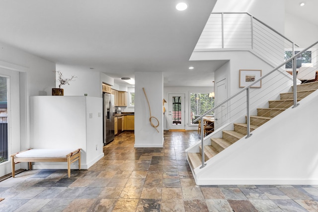 33535 Cherry Ln, Bigfork, MT 59911 - entryway with stone tile flooring, stairs, baseboards, and recessed lighting