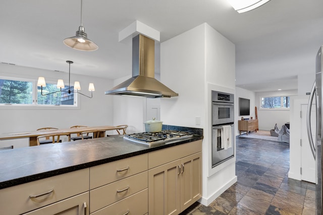 33535 Cherry Ln, Bigfork, MT 59911 - kitchen featuring island exhaust hood, stainless steel appliances, dark countertops, and healthy amount of natural light