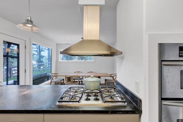 33535 Cherry Ln, Bigfork, MT 59911 - kitchen with island exhaust hood, stainless steel appliances, dark countertops, and pendant lighting