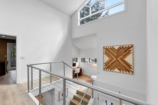 33535 Cherry Ln, Bigfork, MT 59911 - staircase with high vaulted ceiling, wood finished floors, and healthy amount of natural light