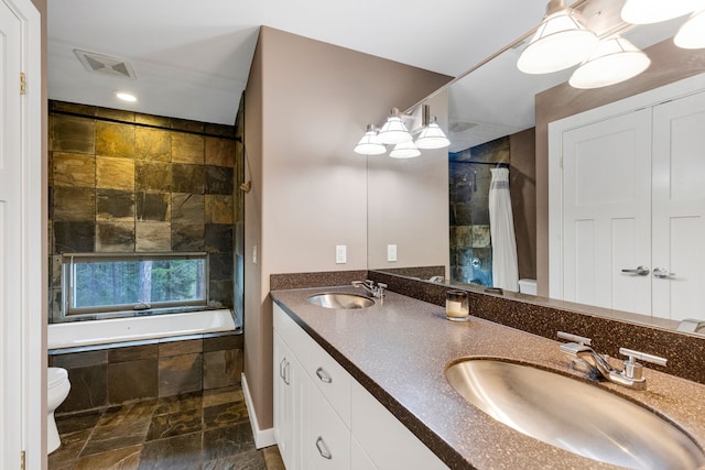 33535 Cherry Ln, Bigfork, MT 59911 - bathroom with double vanity and tiled shower / bath combo