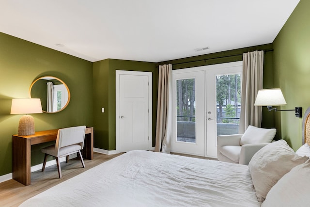 33535 Cherry Ln, Bigfork, MT 59911 - bedroom featuring french doors, access to outside, and wood finished floors