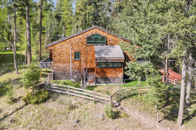 33535 Cherry Ln, Bigfork, MT 59911 - back of house featuring metal roof and a view of trees