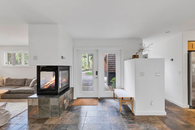 33535 Cherry Ln, Bigfork, MT 59911 - foyer featuring a multi sided fireplace and stone tile floors