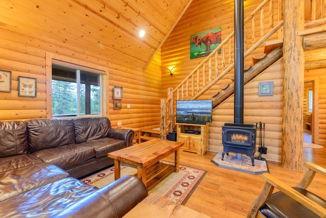 288 Trout Dr, Rexford, MT 59930 - living room featuring rustic walls, a wood stove, high vaulted ceiling, stairs, and wood ceiling