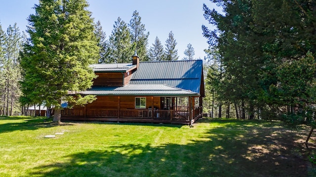 288 Trout Dr, Rexford, MT 59930 - rear view of house featuring a lawn, a chimney, and a metal roof
