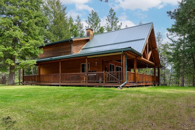 288 Trout Dr, Rexford, MT 59930 - rear view of house with a chimney, a lawn, and a metal roof