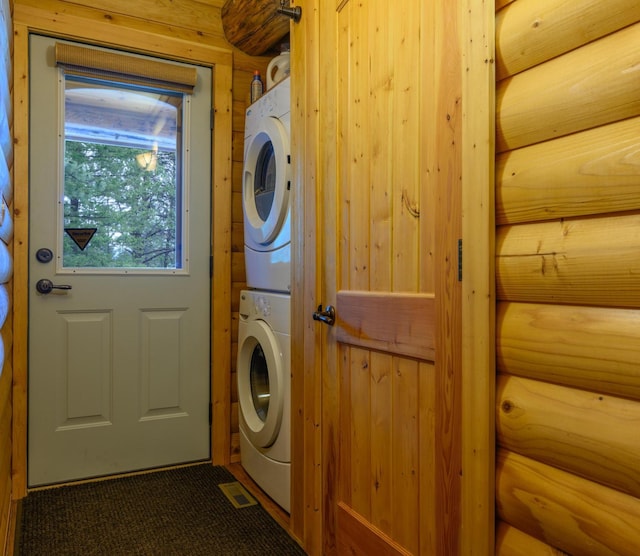 288 Trout Dr, Rexford, MT 59930 - washroom with stacked washer / dryer and rustic walls
