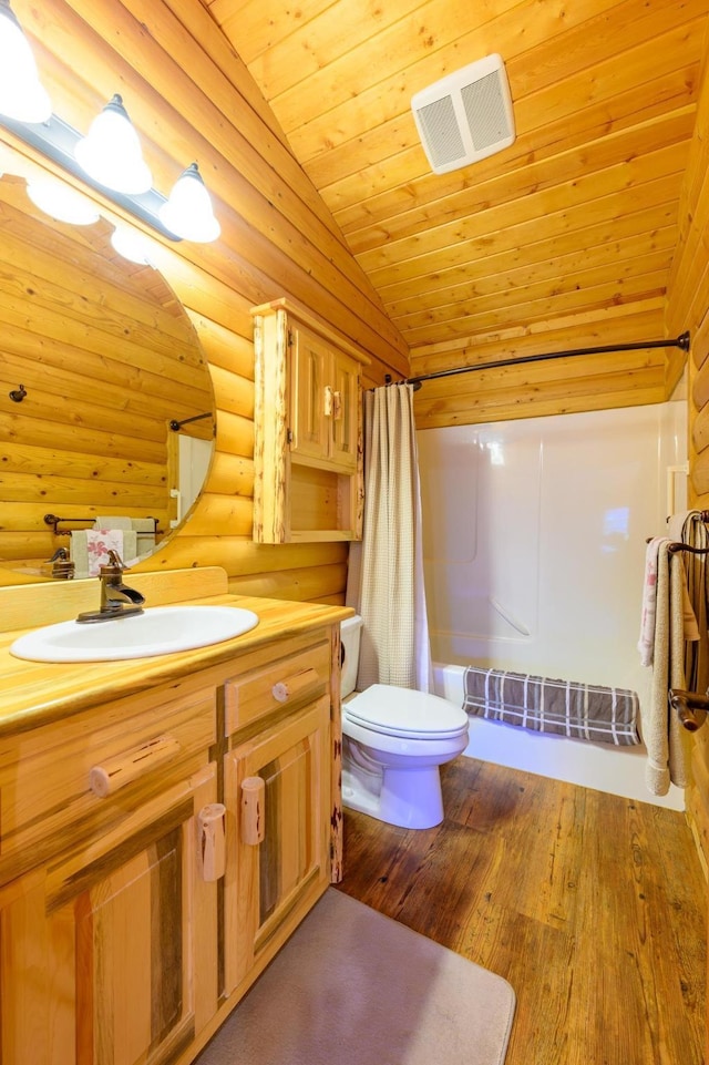 288 Trout Dr, Rexford, MT 59930 - bathroom featuring log walls, vanity, hardwood / wood-style floors, vaulted ceiling, and shower / bath combo with shower curtain