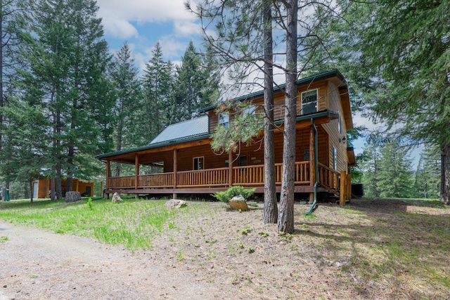 288 Trout Dr, Rexford, MT 59930 - back of property featuring log veneer siding, a metal roof, and covered porch