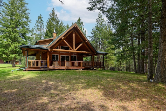 288 Trout Dr, Rexford, MT 59930 - rear view of property featuring a yard, a chimney, a deck, and a metal roof