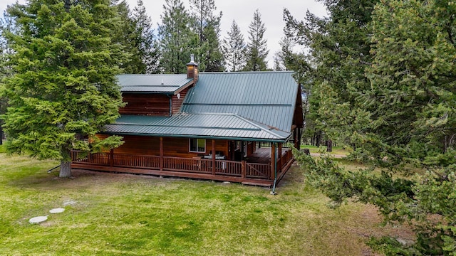 288 Trout Dr, Rexford, MT 59930 - back of house with a lawn, a chimney, and a metal roof