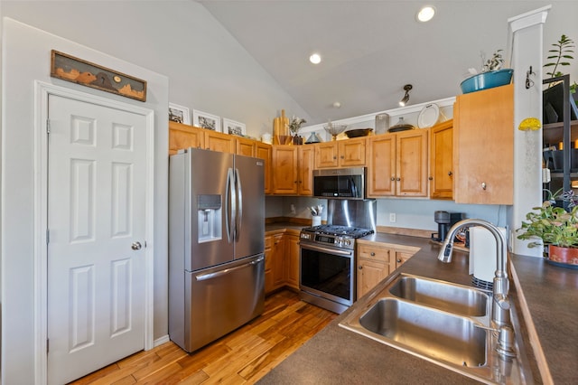 3197 Rose St, Bozeman, MT 59718 - kitchen featuring stainless steel appliances, a sink, dark countertops, light wood-style flooring, and recessed lighting