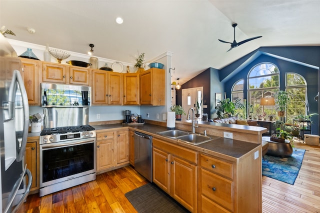3197 Rose St, Bozeman, MT 59718 - kitchen with stainless steel appliances, a sink, a peninsula, dark countertops, and a ceiling fan