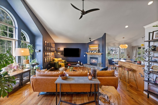 3197 Rose St, Bozeman, MT 59718 - living area featuring lofted ceiling, healthy amount of natural light, ceiling fan, hardwood / wood-style floors, and a tile fireplace