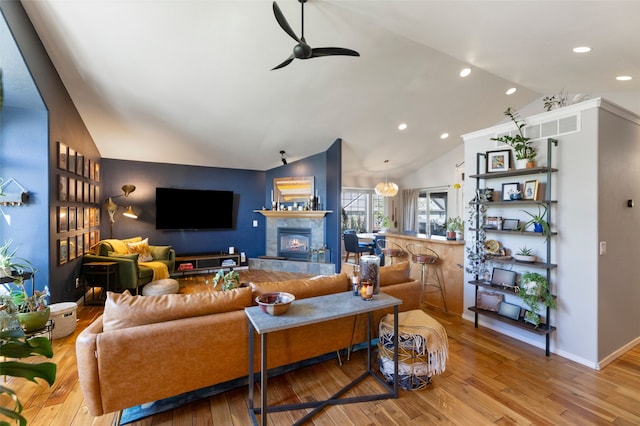 3197 Rose St, Bozeman, MT 59718 - living room with lofted ceiling, a ceiling fan, wood finished floors, a glass covered fireplace, and recessed lighting