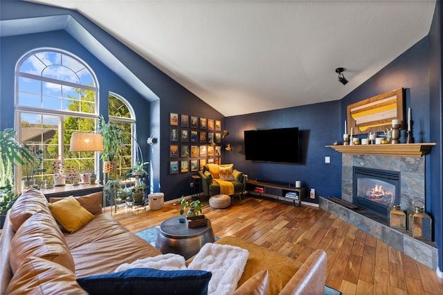 3197 Rose St, Bozeman, MT 59718 - living area featuring vaulted ceiling, hardwood / wood-style flooring, and a fireplace