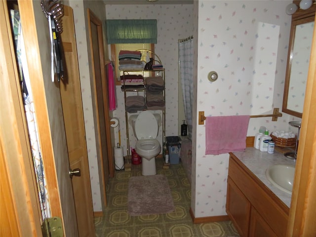 13567 Rosco Rd, Alberton, MT 59820 - bathroom with wallpapered walls, vanity, toilet, and a shower with shower curtain