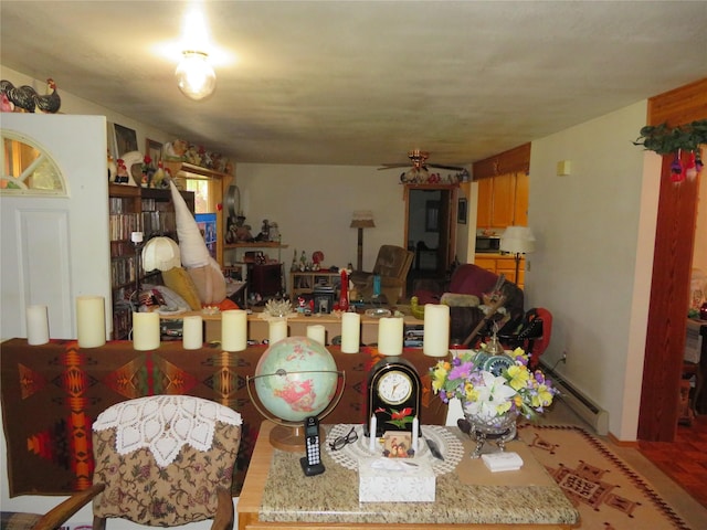 13567 Rosco Rd, Alberton, MT 59820 - dining area featuring a baseboard heating unit and wood finished floors