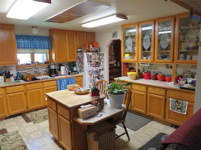 13567 Rosco Rd, Alberton, MT 59820 - kitchen featuring freestanding refrigerator, light countertops, glass insert cabinets, and dishwasher