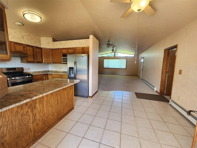 127 Patricia Way, Hamilton, MT 59840 - kitchen featuring stainless steel appliances, lofted ceiling, baseboard heating, ceiling fan, and under cabinet range hood