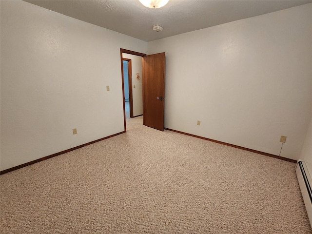 127 Patricia Way, Hamilton, MT 59840 - spare room with light colored carpet, a baseboard radiator, and a smoke detector