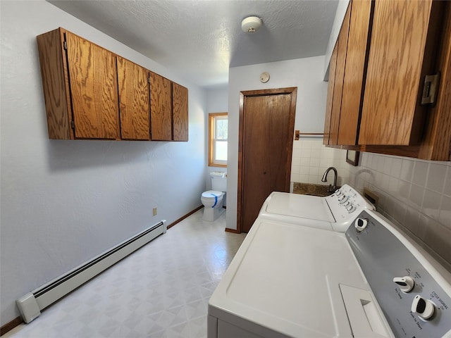 127 Patricia Way, Hamilton, MT 59840 - laundry room with baseboard heating, washing machine and dryer, and light floors