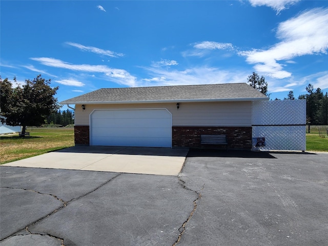 127 Patricia Way, Hamilton, MT 59840 - view of side of home featuring brick siding, a garage, and asphalt driveway