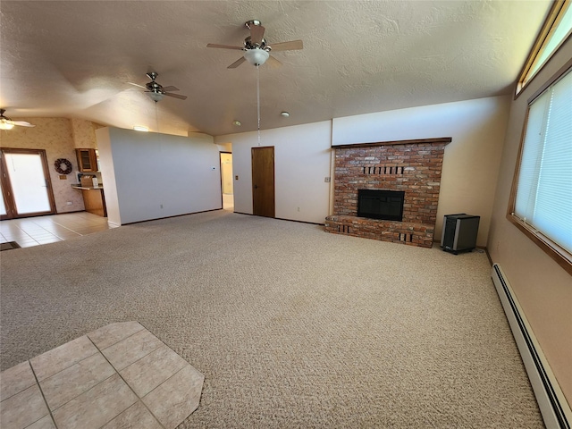 127 Patricia Way, Hamilton, MT 59840 - unfurnished living room featuring baseboard heating, ceiling fan, carpet flooring, a fireplace, and a textured ceiling