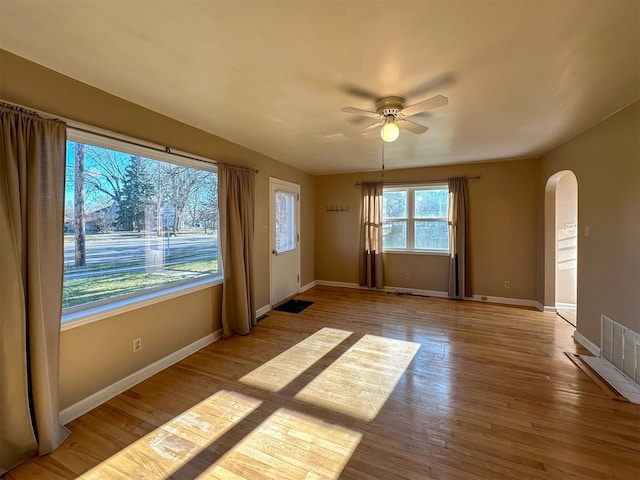 522 Main Ave N, Choteau, MT 59422 - unfurnished room with arched walkways, a ceiling fan, and wood finished floors