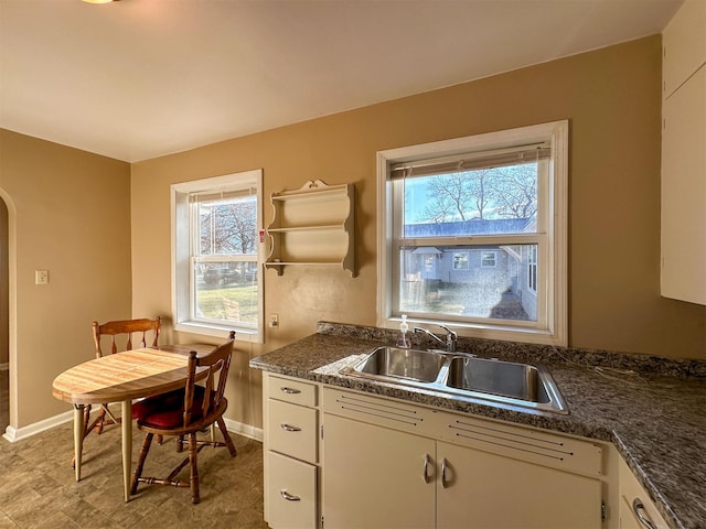522 Main Ave N, Choteau, MT 59422 - kitchen featuring arched walkways, healthy amount of natural light, open shelves, and white cabinetry