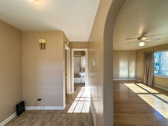 522 Main Ave N, Choteau, MT 59422 - unfurnished room featuring arched walkways, wood finished floors, and ceiling fan
