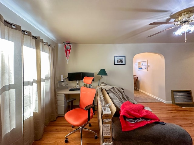 522 Main Ave N, Choteau, MT 59422 - home office with arched walkways, wood finished floors, and ceiling fan