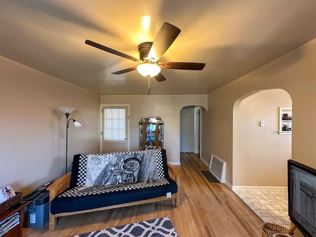 522 Main Ave N, Choteau, MT 59422 - living room with arched walkways, ceiling fan, and light wood-style floors