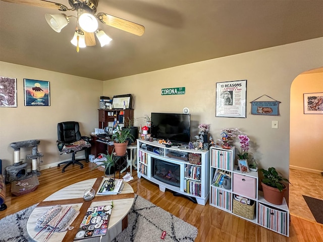 522 Main Ave N, Choteau, MT 59422 - living room with arched walkways, ceiling fan, and wood finished floors
