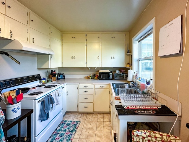 522 Main Ave N, Choteau, MT 59422 - kitchen with electric stove, under cabinet range hood, light countertops, and light tile patterned flooring