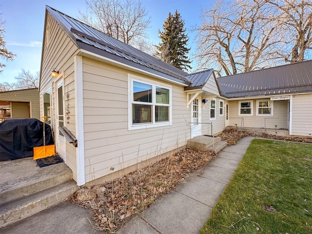 522 Main Ave N, Choteau, MT 59422 - view of property exterior with a metal roof and a yard