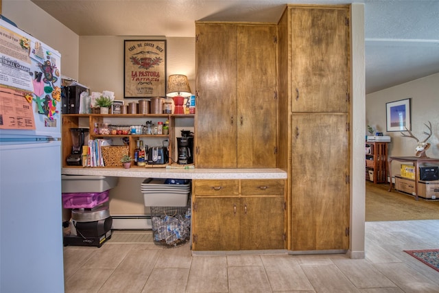 413 S 8th St, Hamilton, MT 59840 - bar area featuring a baseboard radiator, freestanding refrigerator, and light wood-type flooring