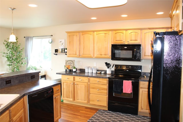 1230 Lucchese Rd, Helena, MT 59602 - kitchen featuring black appliances, light brown cabinetry, light wood-style flooring, dark countertops, and recessed lighting