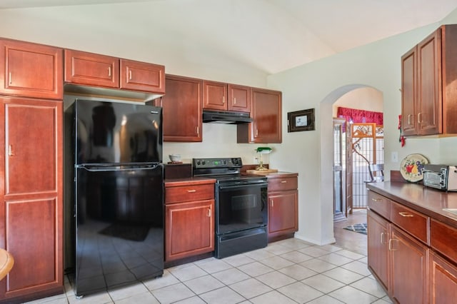 142 Thomas St, Hamilton, MT 59840 - kitchen featuring black appliances, under cabinet range hood, arched walkways, vaulted ceiling, and light tile patterned floors