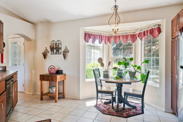 142 Thomas St, Hamilton, MT 59840 - dining room with plenty of natural light, arched walkways, light tile patterned flooring, and vaulted ceiling