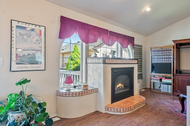 142 Thomas St, Hamilton, MT 59840 - living room with a glass covered fireplace, wood finished floors, lofted ceiling, and an AC wall unit