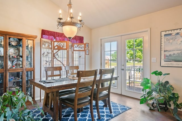 142 Thomas St, Hamilton, MT 59840 - dining area featuring vaulted ceiling, french doors, a chandelier, and wood finished floors