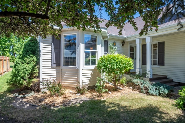 142 Thomas St, Hamilton, MT 59840 - view of home's exterior with a porch, a lawn, and a shingled roof