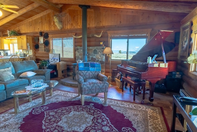 347 Upper Ross Gulch Rd, Townsend, MT 59644 - living area with a wood stove, healthy amount of natural light, wood finished floors, wood walls, and wood ceiling